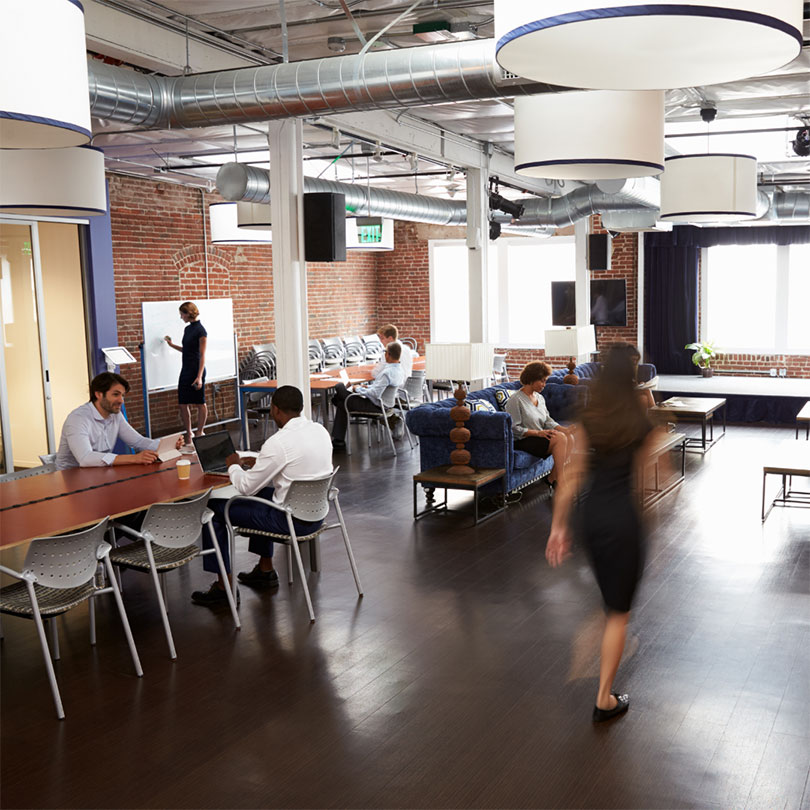 An open-concept office space with busy office workers.